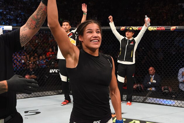 HOUSTON, TX - OCTOBER 03:  Julianna Pena exchanges celebrates her victory over Jessica Eye in their women's bantamweight bout during the UFC 192 event at the Toyota Center on October 3, 2015 in Houston, Texas. (Photo by Josh Hedges/Zuffa LLC/Zuffa LLC via Getty Images)
