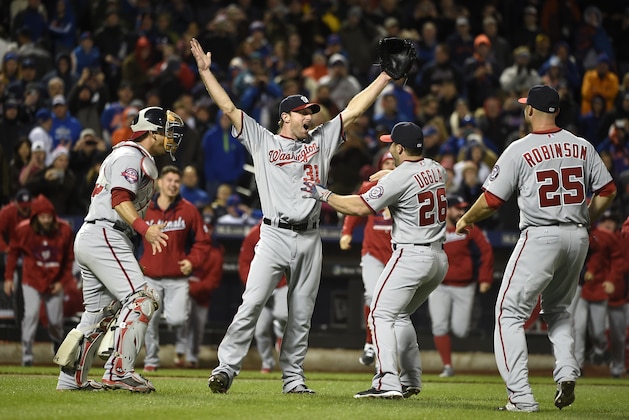 Max Scherzer, segundo a la izquierda, celebra con sus compañeros de los Nacionales de Washington tras lanzar un juego si hits, el sábado 3 de octubre de 2015. (AP Foto/Kathy Kmonicek)