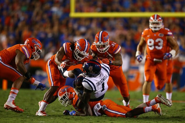 GAINESVILLE, FL - OCTOBER 03: Laquon Treadwell #1 of the Mississippi Rebels is stopped by Daniel McMillian #13 and Jalen Tabor #31 of the Florida Gators during the first half of the game on October 3, 2015 in Gainesville, Florida.  (Photo by Rob Foldy/Getty Images)