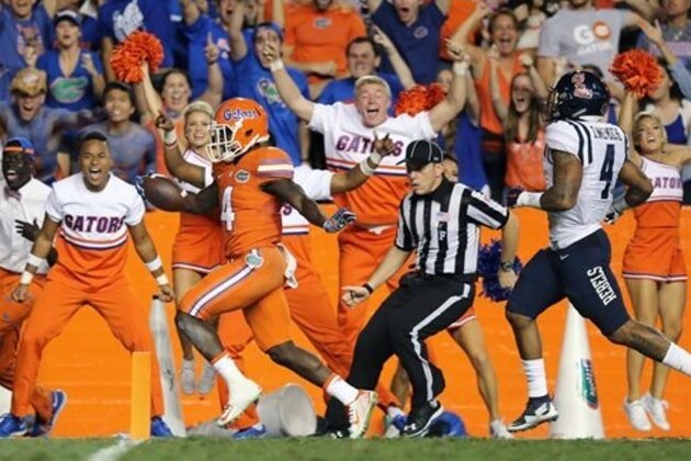 Florida wide receiver Brandon Powell (4) scores on a 77-yard reception in front of Mississippi linebacker Denzel Nkemdiche (4), right, during the first half of an NCAA college football game Saturday, Oct. 3, 2015, in Gainesville, Fla. (AP Photo/Gary McCullough)