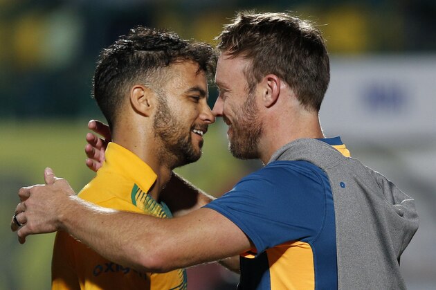 South Africa's Jean-Paul Duminy, left, celebrates with teammate AB de Villiers after winning the first Twenty20 match against India in Dharmsala, India, Friday, Oct. 2, 2015. (AP Photo /Tsering Topgyal)