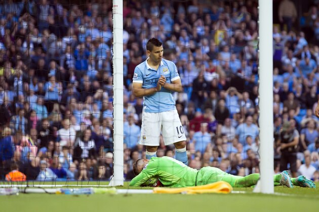 Manchester City's Sergio Aguero, top, reacts after a missed opportunity during the English Premier League soccer match between Manchester City and West Ham United at the Etihad Stadium, Manchester, England, Saturday Sept. 19, 2015. (AP Photo/Jon Super)