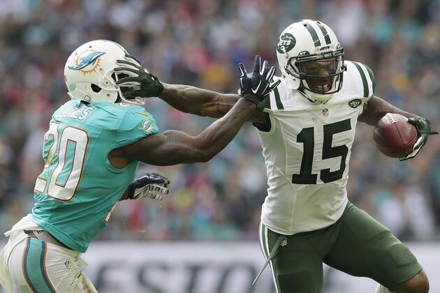 New York Jets' Brandon Marshall, right, fends off Miami Dolphins' Reshad Jones during the NFL football game between the New York Jets and the Miami Dolphins and at Wembley stadium in London, Sunday, Oct. 4, 2015. (AP Photo/Tim Ireland)