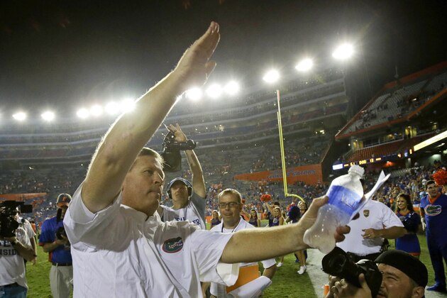 Florida head coach Jim McElwain celebrates with the gator chomp in front of fans after defeating New Mexico State  61-13 in an NCAA college football game, Saturday, Sept. 5, 2015, in Gainesville, Fla.  (AP Photo/John Raoux)