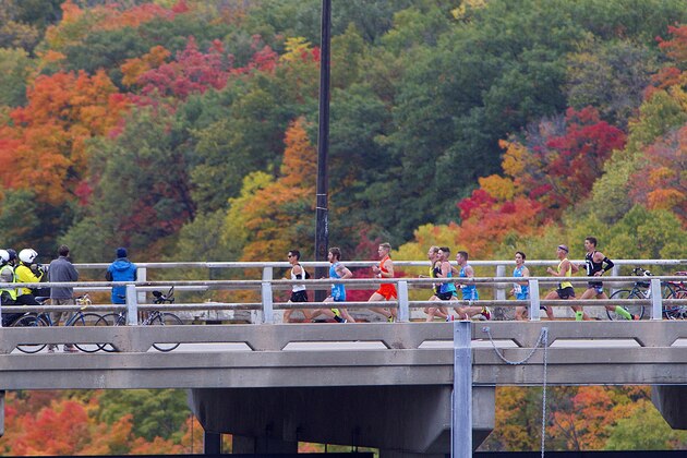 The lead pack of runners cross the Mississippi River on the Franklin Ave bridge during the Twin Cities Marathon on Sunday, Oct. 5, 2014 in Minneapolis.  (AP Photo/Andy Clayton-King)