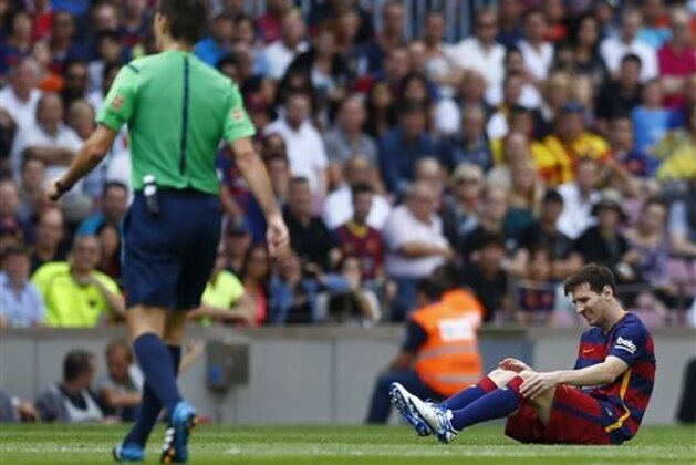 FC Barcelona's Lionel Messi, from Argentina, reacts after getting injured during a Spanish La Liga soccer match against Las Palmas at the Camp Nou stadium in Barcelona, Spain, Saturday, Sept. 26, 2015. (AP Photo/Manu Fernandez)