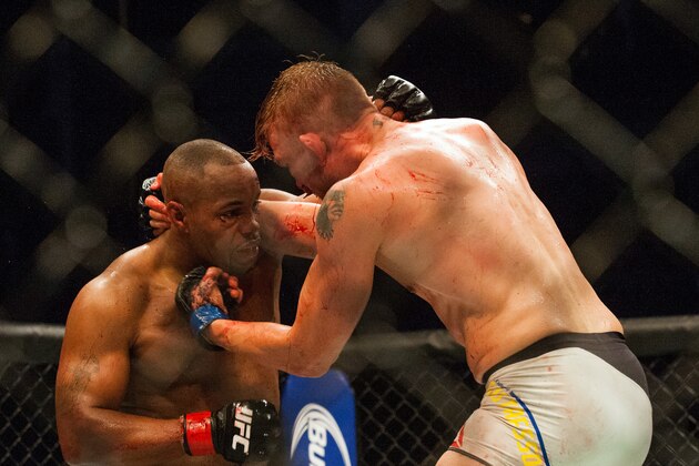 UFC Light Heavyweight champ Daniel Cormier, left, takes an uppercut from challenger Alexander Gustasson during a mixed material arts bout at MMA UFC 192, Saturday, Oct. 3, 2015 in Houston,  (AP Photo/Juan DeLeon)
