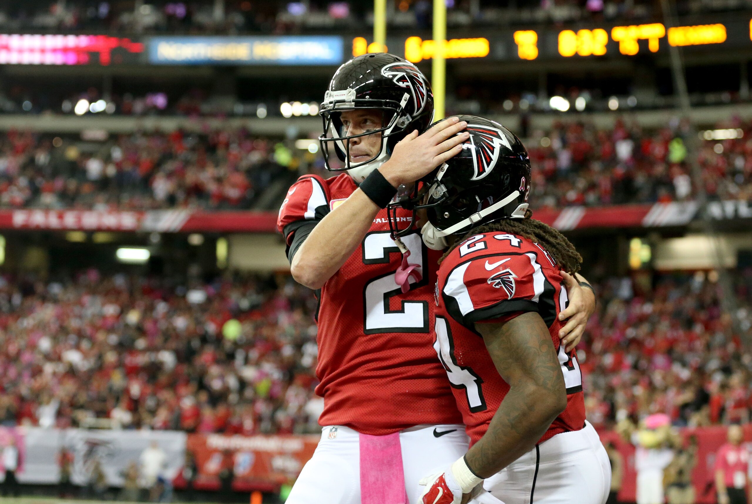 Oct 4, 2015; Atlanta, GA, USA; Atlanta Falcons running back Devonta Freeman (24) celebrates his touchdown run with quarterback Matt Ryan (2) in the first quarter of their game against the Houston Texans at the Georgia Dome. Mandatory Credit: Jason Getz-USA TODAY Sports