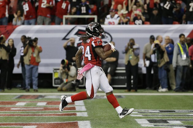 Atlanta Falcons running back Devonta Freeman (24) scores a touchdown against the Houston Texans during the first half of an NFL football game, Sunday, Oct. 4, 2015, in Atlanta. (AP Photo/David Goldman)