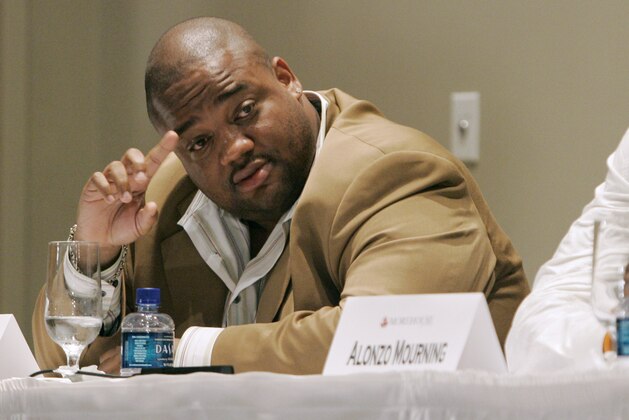 Journalist Jason Whitlock, left tries to get a word in as former NBA all star Alonzo Mourning listens during a panel discussion about  the black athlete, held at Morehouse College, Monday May 7, 2007, in Atlanta. Whitlock took heat during much of the discussion for a newspaper column he wrote condemning fellow panelist Vivian Stringer for her reactions to the infamous Don Imus comments. (AP Photo/John Amis)