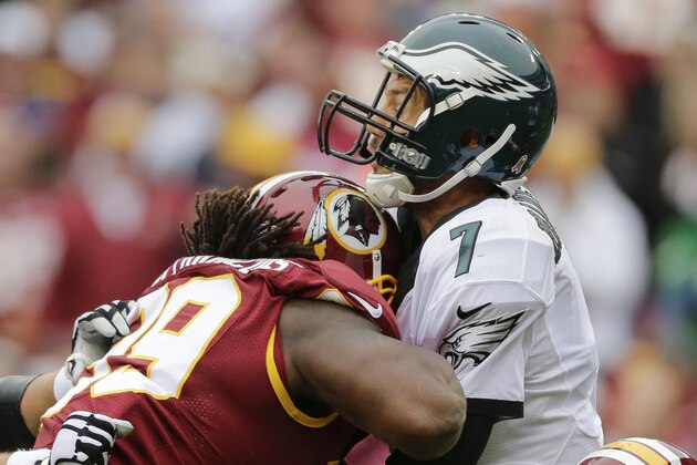 Philadelphia Eagles quarterback Sam Bradford (7) takes a shot in the chin from Washington Redskins defensive tackle Ricky Jean Francois (99) during the second half of an NFL football game in Landover, Md., Sunday, Oct. 4, 2015. (AP Photo/Mark Tenally)