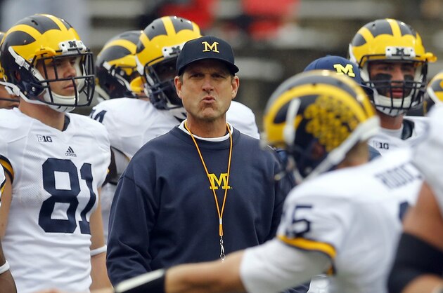 Michigan head coach Jim Harbaugh watches his players warm up before an NCAA college football game against Maryland, Saturday, Oct. 3, 2015, in College Park, Md. (AP Photo/Patrick Semansky)