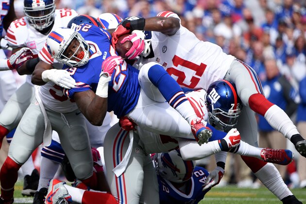Buffalo Bills running back Karlos Williams, center, is tackled by New York Giants players during the first half of an NFL football game, Sunday, Oct. 4, 2015, in Orchard Park, N.Y. (AP Photo/Gary Wiepert)