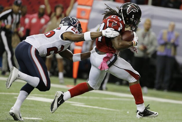 Atlanta Falcons running back Devonta Freeman (24) heads to the end zone for a touchdown against Houston Texans free safety Rahim Moore (26) during the first half of an NFL football game, Sunday, Oct. 4, 2015, in Atlanta. (AP Photo/David Goldman)