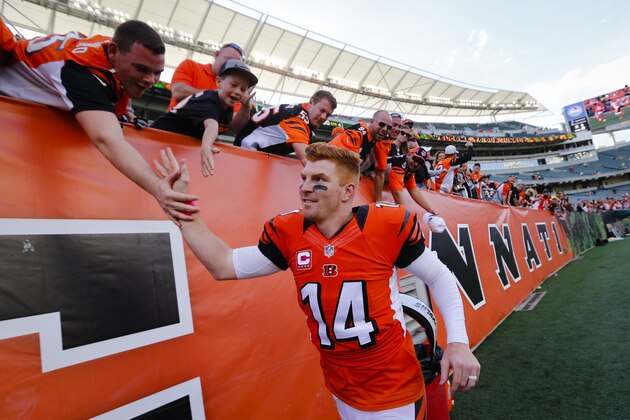 Cincinnati Bengals quarterback Andy Dalton celebrates with fans after an NFL football game against the Kansas City Chiefs, Sunday, Oct. 4, 2015, in Cincinnati. The Bengals won 36-21. (AP Photo/Paul Sancya)