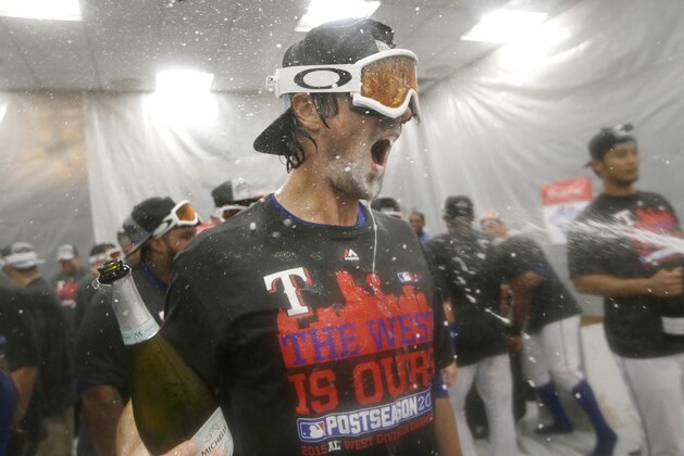 Texas Rangers starting pitcher Cole Hamels celebrates in the clubhouse with teammates after a baseball game against the Los Angeles Angels in Arlington, Texas, Sunday, Oct. 4, 2015. The finally clinched the AL West title on the last day of the regular season with the 9-2 win over the Angels. (AP Photo/LM Otero) Texas Rangers starting pitcher Cole Hamels celebrates in the clubhouse with teammates after a baseball game against the Los Angeles Angels in Arlington, Texas, Sunday, Oct. 4, 2015. The finally clinched the AL West title on the last day of the regular season with the 9-2 win over the Angels. (AP Photo/LM Otero)
