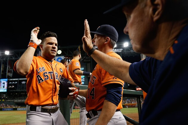 PHOENIX, AZ - OCTOBER 03:  Jose Altuve #27 of the Houston Astros high fives pitching coach Brent Strom #53 after Altuve hit a solo home-run against the Arizona Diamondbacks during the fifth inning of the MLB game at Chase Field on October 3, 2015 in Phoenix, Arizona.  (Photo by Christian Petersen/Getty Images)