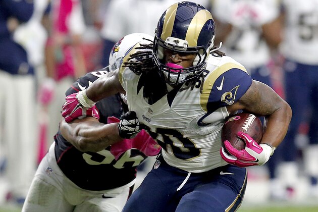 St. Louis Rams running back Todd Gurley (30) eludes the reach of Arizona Cardinals outside linebacker LaMarr Woodley (56) during the second half of an NFL football game, Sunday, Oct. 4, 2015, in Glendale, Ariz. (AP Photo/Rick Scuteri)