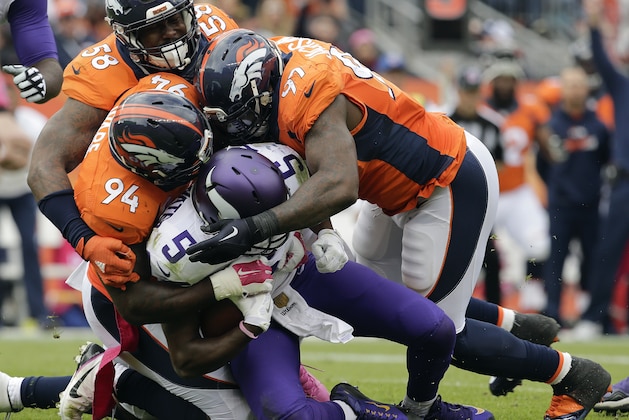 Minnesota Vikings quarterback Teddy Bridgewater (5) is sacked by Denver Broncos outside linebacker Von Miller (58) outside linebacker DeMarcus Ware (94) and defensive end Malik Jackson (97) during the first half of an NFL football game Sunday, Oct. 4, 2015, in Denver. (AP Photo/Joe Mahoney)