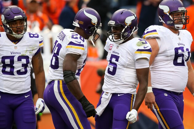 DENVER, CO - OCTOBER 4:  Running back Adrian Peterson #28 of the Minnesota Vikings and Teddy Bridgewater #5 celebrate a fourth quarter Peterson touchdown against the Denver Broncos at Sports Authority Field at Mile High on October 4, 2015 in Denver, Colorado.  (Photo by Doug Pensinger/Getty Images)