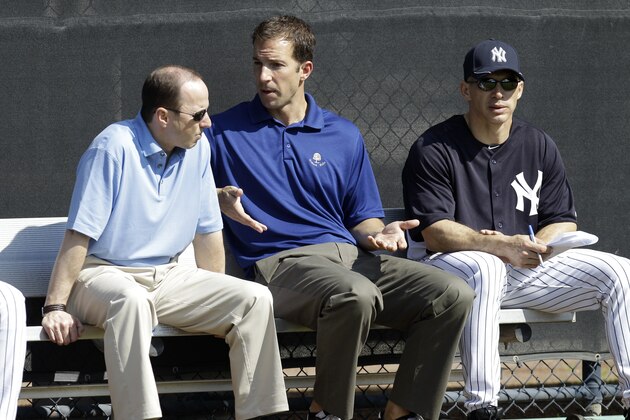 New York Yankees General Manager Brian Cashman, left, Director of Professional Scouting Billy Eppler, center, and manager Joe Girardi sit in the bullpen during a baseball spring training workout Wednesday, Feb. 16, 2011, at Steinbrenner Field in Tampa, Fla. (AP Photo/Charlie Neibergall)