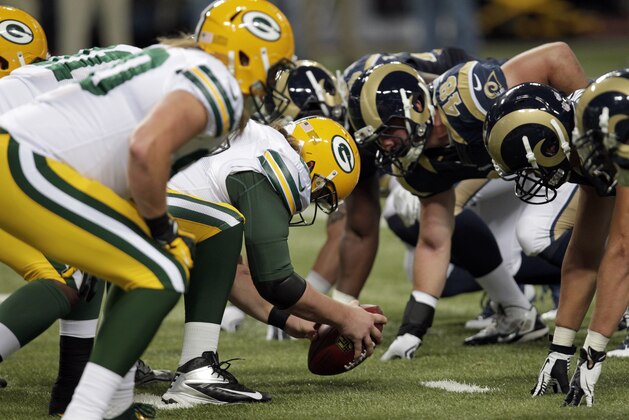 Members of the Green Bay Packers and St. Louis Rams are seen on the line of scrimmage during the fourth quarter of an NFL preseason football game Saturday, Aug. 16, 2014, in St. Louis. The Packers won 21-7. (AP Photo/Tom Gannam)