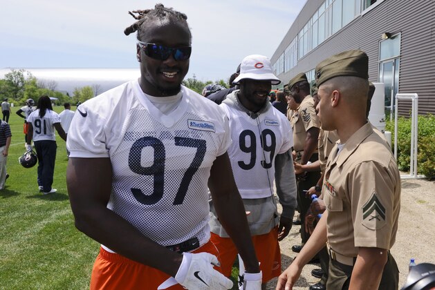 Chicago Bears linebacker's Willie Young, left, and Lamarr Houston greet a group of visiting Marines from unit 224 in Chicago after an NFL football organized team activity at Halas Hall, Wednesday, June 10, 2015, in Lake Forest, Ill. (AP Photo/Matt Marton)