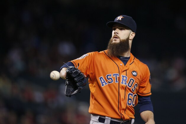 Houston Astros' Dallas Keuchel gets a new baseball during the first inning of a baseball game against the Arizona Diamondbacks Friday, Oct. 2, 2015, in Phoenix. (AP Photo/Ross D. Franklin)