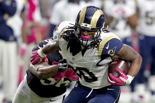 St. Louis Rams running back Todd Gurley (30) eludes the reach of Arizona Cardinals outside linebacker LaMarr Woodley (56) during the second half of an NFL football game, Sunday, Oct. 4, 2015, in Glendale, Ariz. (AP Photo/Rick Scuteri)