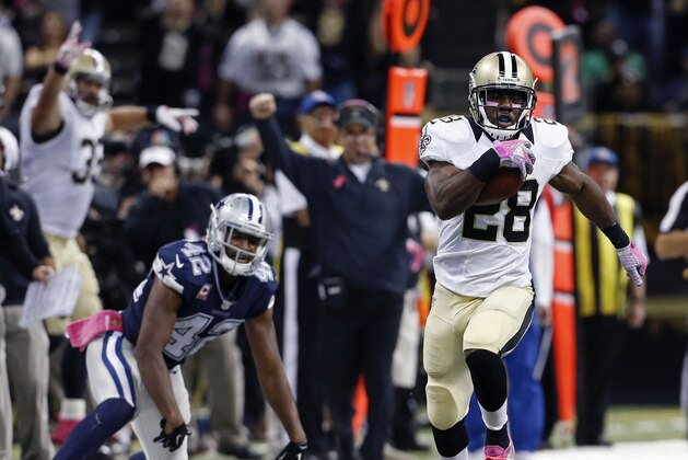 New Orleans Saints running back C.J. Spiller (28) scores the game-winning touchdown during overtime of an NFL football game against the Dallas Cowboys in New Orleans, Sunday, Oct. 4, 2015. The Saints won 26-20. (AP Photo/Jonathan Bachman)