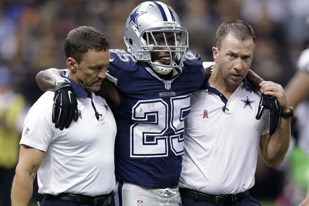 Dallas Cowboys running back Lance Dunbar (25) is helped off the field in the second half of an NFL football game against the New Orleans Saints in New Orleans, Sunday, Oct. 4, 2015. (AP Photo/Brynn Anderson)
