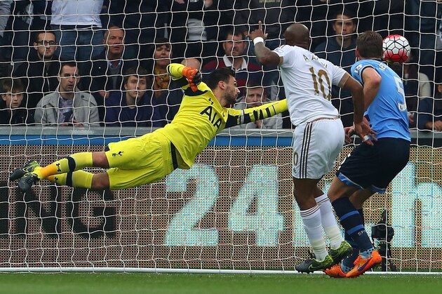 Swansea City's Andre Ayew (C) heads past Tottenham Hotspur's Belgian defender Jan Vertonghen (R) to score Swansea's first goal during the English Premier League football match between Swansea City and Tottenham Hotspurs at The Liberty Stadium in Swansea, south Wales on October 4, 2015.     AFP PHOTO / GEOFF CADDICK

RESTRICTED TO EDITORIAL USE. No use with unauthorized audio, video, data, fixture lists, club/league logos or 'live' services. Online in-match use limited to 75 images, no video emulation. No use in betting, games or single club/league/player publications.        (Photo credit should read GEOFF CADDICK/AFP/Getty Images)