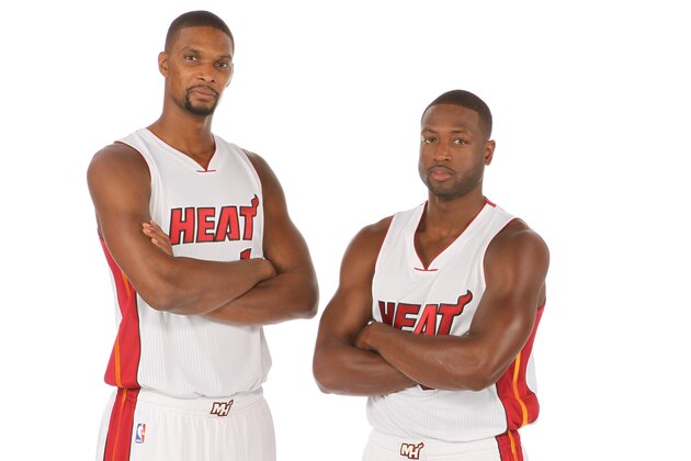 MIAMI, FL - September 28:  Chris Bosh #1 and Dwyane Wade #3 of the Miami Heat pose for a portrait during media day at the American Airlines Arena in Miami, Florida on September 28, 2015. NOTE TO USER: User expressly acknowledges and agrees that, by downloading and/or using this photograph, user is consenting to the terms and conditions of the Getty Images License Agreement. Mandatory copyright notice: Copyright NBAE 2015 (Photo by Issac Baldizon/NBAE via Getty Images)