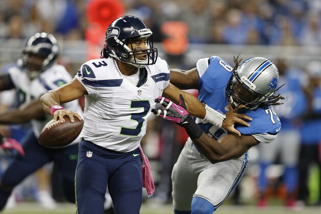 DETROIT, MI - OCTOBER 28: Russell Wilson #3 of the Seattle Seahawks looks to pass while under pressure from Willie Young #79 of the Detroit Lions during the game at Ford Field on October 28, 2012 in Detroit, Michigan. The Lions won 28-24. (Photo by Joe Robbins/Getty Images)