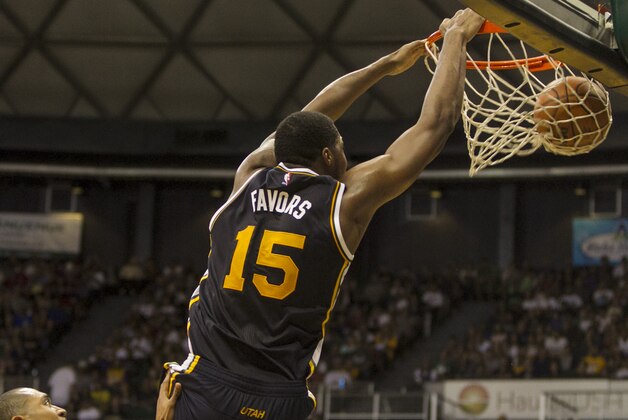 Utah Jazz forward Derrick Favors (15) makes a basket against the Los Angeles Lakers during the third quarter of a preseason NBA basketball game, Sunday, Oct. 4. 2015, in Honolulu. (AP Photo/Marco Garcia)
