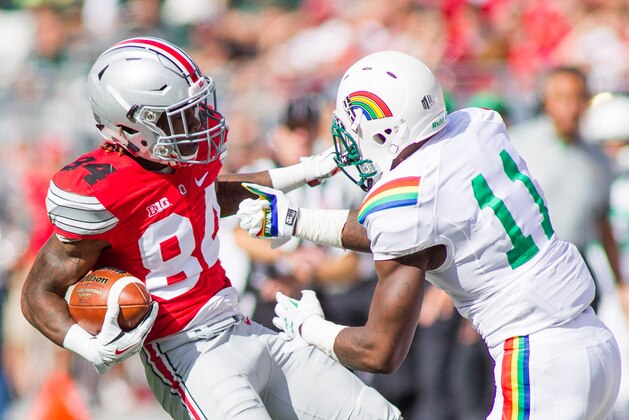 Sep 12, 2015; Columbus, OH, USA; Ohio State Buckeyes wide receiver Corey Smith (84) avoids a tackle during the game against the Hawaii Warriors at Ohio Stadium. The Ohio State Buckeyes beat the Hawaii Warriors by the score of 38-0. Mandatory Credit: Trevor Ruszkowski-USA TODAY Sports