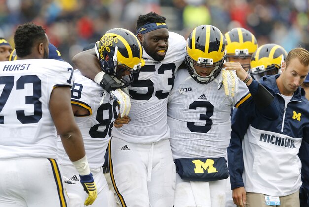 Michigan defensive end Mario Ojemudia (53) is assisted off the field after injuring himself on a play in the second half of an NCAA college football game against Maryland, Saturday, Oct. 3, 2015, in College Park, Md. (AP Photo/Patrick Semansky)