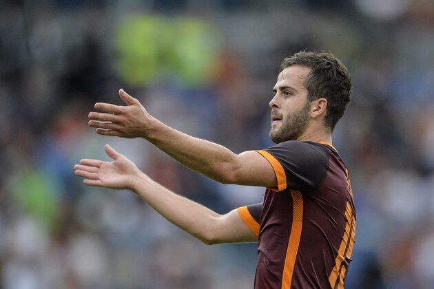 Roma's midfielder from Bosnia-Herzegovina Miralem Pjanic celebrates with after scoring during the Italian Serie A football match Roma vs Carpi on September 26, 2015 at Rome's Olympic stadium. AFP PHOTO / ANDREAS SOLARO        (Photo credit should read ANDREAS SOLARO/AFP/Getty Images)