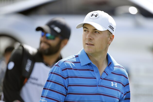 Jordan Spieth looks at a vocal fan in the stands after hitting his tee shot on the first hole during the third round of the BMW Championship golf tournament at Conway Farms Golf Club, Saturday, Sept. 19, 2015, in Lake Forest, Ill. (AP Photo/Charles Rex Arbogast)