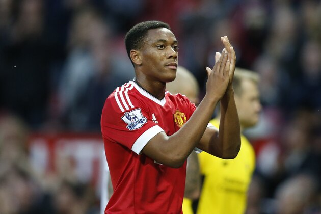 Manchester United's Anthony Martial applauds the crowd after the English Premier League soccer match between Manchester United and Liverpool at Old Trafford Stadium, Manchester, England, Saturday, Sept. 12, 2015. (AP Photo/Jon Super)