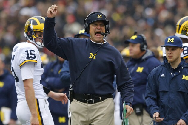 Michigan head coach Jim Harbaugh calls for a flag in the first half of an NCAA college football game against Maryland, Saturday, Oct. 3, 2015, in College Park, Md. (AP Photo/Patrick Semansky)