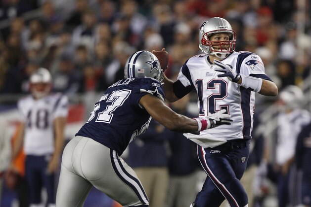 New England Patriots quarterback Tom Brady (12) tries to scramble away from Dallas Cowboys linebacker Victor Butler during the second half NFL football game in Foxborough, Mass., Sunday, Oct. 16, 2011. The Patriots beat the Cowboys 20-16. (AP Photo/Charles Krupa)