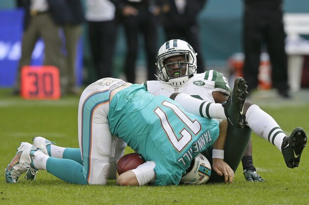 Miami Dolphins' Ryan Tannehill is sacked during the NFL football game between the New York Jets and the Miami Dolphins and at Wembley stadium in London, Sunday, Oct. 4, 2015. (AP Photo/Tim Ireland)