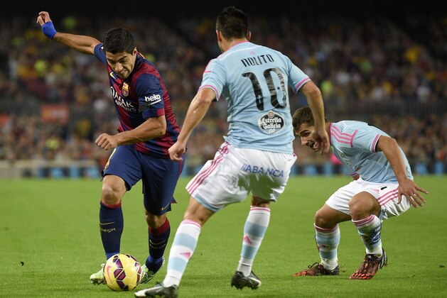 Barcelona's Uruguayan forward Luis Suarez (L) vies with Celta Vigo's Celta Vigo's forward Nolito (C) and Celta Vigo's Chilean forward Fabian Orellana (R) during the Spanish league football match FC Barcelona vs RC Celta de Vigo at the Camp Nou stadium in Barcelona on November 1, 2014.   AFP PHOTO / LLUIS GENE        (Photo credit should read LLUIS GENE/AFP/Getty Images)