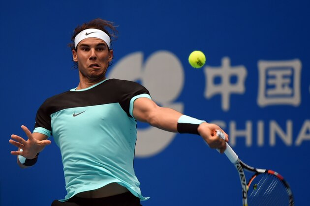 Rafael Nadal of Spain hits a return against Wu Di of China during their first round men's singles match at the China Open tennis tournament in Beijing on October 6, 2015.         AFP PHOTO / GOH CHAI HIN        (Photo credit should read GOH CHAI HIN/AFP/Getty Images)