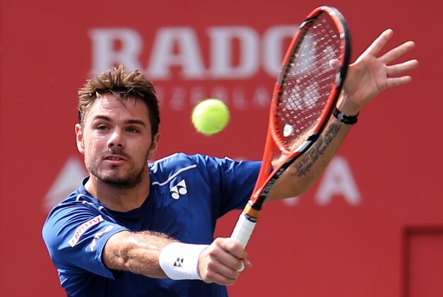 Stan Wawrinka of Switzerland returns a shot against Czech Republic's Radek Stepanek in their men's singles first round match at the Japan Open men’s tennis tournament in Tokyo, Tuesday, Oct. 6, 2015. (AP Photo/Eugene Hoshiko)
