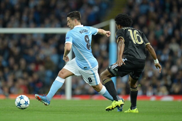 Manchester City's French midfielder Samir Nasri (L) controls the ball by Juventus' forward from Coombia Juan Cuadrado during a UEFA Champions League group stage football match between Manchester City and Juventus at the Etihad stadium in Manchester, north-west England on September 15, 2015.      AFP PHOTO / OLI SCARFF        (Photo credit should read OLI SCARFF/AFP/Getty Images)