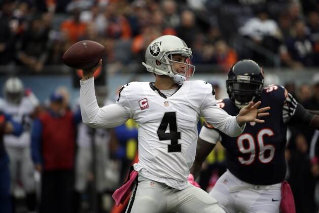 Oakland Raiders quarterback Derek Carr (4) throws a pass as Chicago Bears defensive end Jarvis Jenkins (96) pressures him during the first half of an NFL football game, Sunday, Oct. 4, 2015, in Chicago. (AP Photo/Nam Y. Huh)