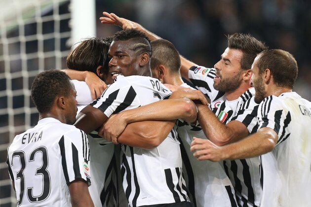 Juventus' midfielder Sami Khedira from Germany celebrates with teammates after scoring during the Italian Serie A  football match Juventus Vs Bologna on October 4, 2015 at the 'Juventus Stadium' in Turin.  AFP PHOTO / MARCO BERTORELLO        (Photo credit should read MARCO BERTORELLO/AFP/Getty Images)