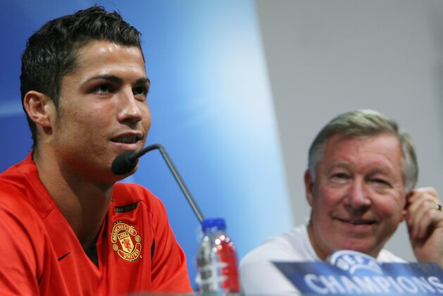 Manchester United player Cristiano Ronaldo, left, answers a journalists question as manager Sir Alex Ferguson looks on  during a press conference Tuesday, Sept. 18 2007 at Alvalade stadium in Lisbon, Portugal. Manchester United will play Sporting in a Champions League Group F soccer match Wednesday. Other teams in the group are AS Roma and Dynamo Kiev. (AP Photo/Steven Governo)